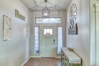 Entrance foyer with wood finished floors and a textured wall