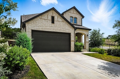 French country style house featuring brick siding