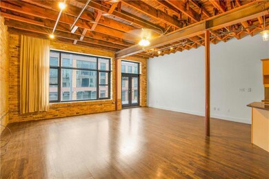 Below grade area with brick wall, baseboards, and