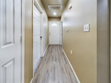 Entryway with light wood-style floors, baseboards,