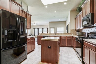 Kitchen With Dark Stained 42 Inch Cabinets*Island*Gas Cooking*Tile Backsplash & Tile Floors.