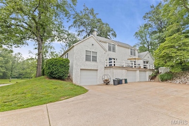View of pole building with dirt driveway and a yard