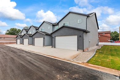 Traditional-style house featuring concrete driveway and stucco siding