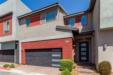 View of front facade featuring stucco siding, driv