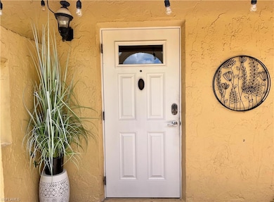 Doorway to property with stucco siding