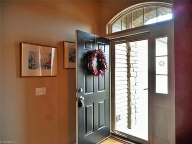 The two  foyer has hickory  wood floors and welcom
