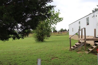 View of mobile home featuring a wooden deck