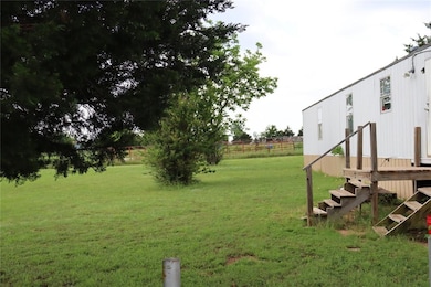 View of mobile home featuring a wooden deck