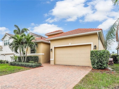 Mediterranean / spanish-style home featuring a gar