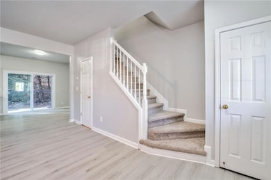 Staircase featuring light hardwood / wood-style fl