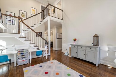 Foyer/entrance room with exposed staircase