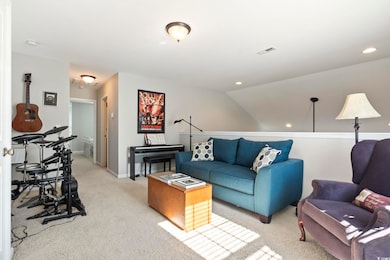 Living room featuring lofted ceiling and light car