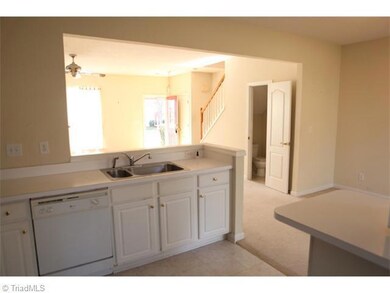 Kitchen. Full view toward the entryway and stairway as seen from the kitchen.