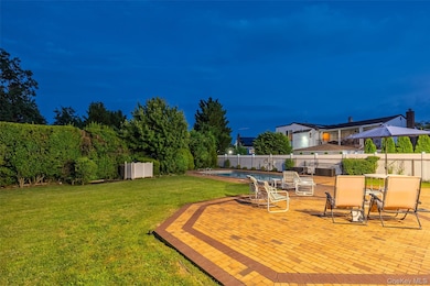 Yard at twilight with a patio and a fenced backyard