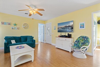 Living room with visible vents, baseboards, and li