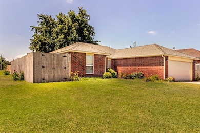 Ranch-style house with a garage, brick siding, a shingled roof, and a front yard