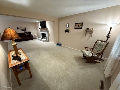 Living area with carpet floors and a brick fireplace