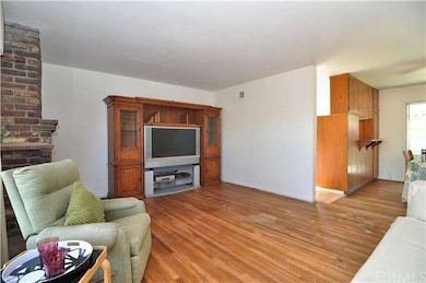 Fireplace, smooth ceilings and hardwood floors.