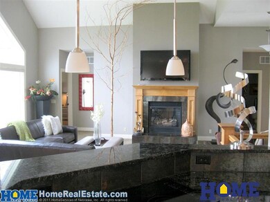 Great room features a direct-vent gas fireplace and high ceiling for a very open feel
