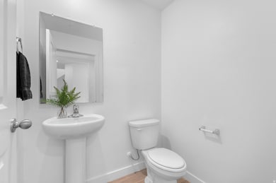 Bathroom with baseboards and wood finished floors