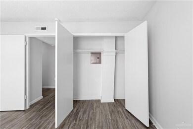 Unfurnished room with dark wood-type flooring