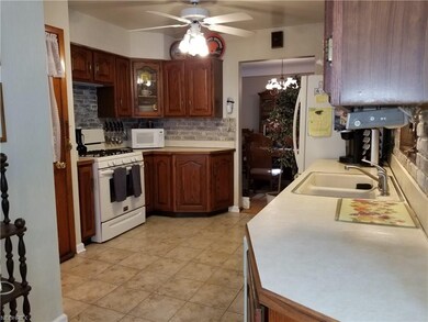 Large Eat-in Kitchen with Raised Panel Cabinets and Plenty of Counter Space - Neutral Ceramic Tiled Floor