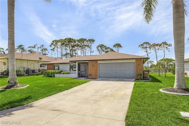 Ranch-style home with an attached garage, concrete