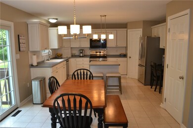 Large kitchen with island, stainless steel appliances, touch faucet, huge pantry, chandelier lighting and so much more.