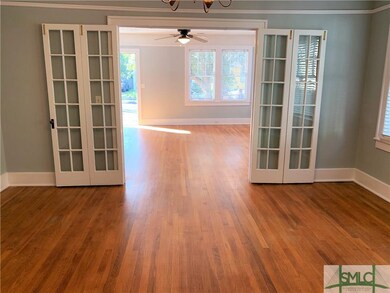 Living room opens to dining room with original acc