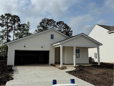 View of front facade with a garage and concrete dr