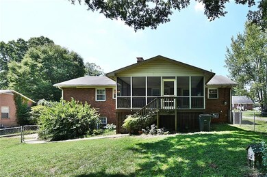 Back of home with focal point of generous screened porch