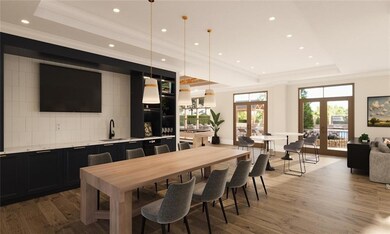 Dining space featuring a raised ceiling, hardwood 