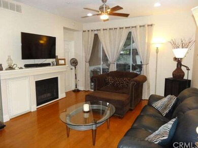 Spacious living room features beautiful wood floor