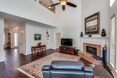 Living room with a high ceiling, a fireplace, dark