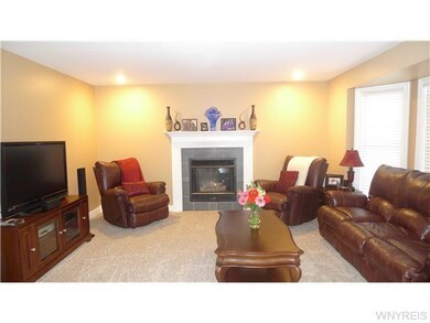 Family Room Entertain guests by the fireplace in t