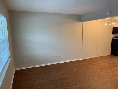 Unfurnished living room featuring baseboards, a no
