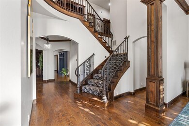 Foyer entrance with dark wood-type flooring, decor