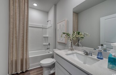 Full bath featuring shower / bath combo, wood fini