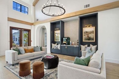 Living room with beamed ceiling, a towering ceilin