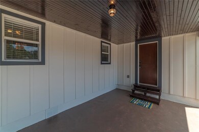 FRONT PORCH WITH STAINED PLANK CEILING AND PAINTED