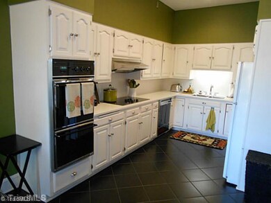 Kitchen. Kitchen has double oven, cook top, dishwasher, solid surface counter tops and airy ceilings.