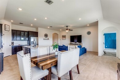 Dining room with arched walkways, ceiling fan, light tile patterned flooring, and recessed lighting