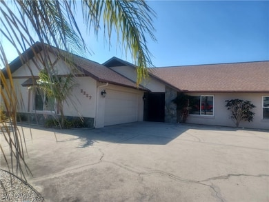 Ranch-style home featuring a garage, stucco siding