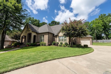 View of front of property with brick siding, concrete driveway, a garage, and a shingled roof