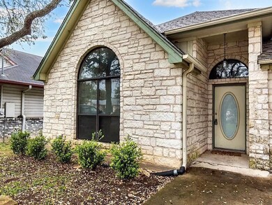 Property entrance featuring stone siding and roof