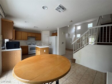 Dining area featuring light tile patterned flooring, stairs, and a textured ceiling