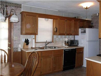 Large kitchen with oak cabinets and vinyl flooring