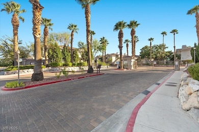 View of street with a gate, curbs, sidewalks, a gated entry, and a residential view