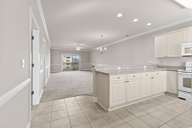Kitchen featuring ceiling fan with notable chandel