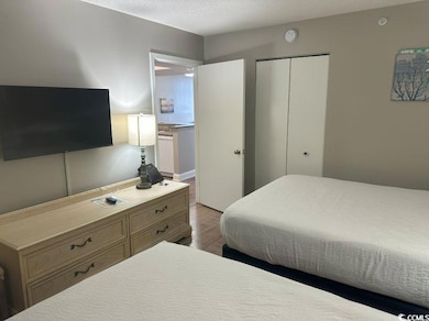 Bedroom featuring light hardwood / wood-style floo